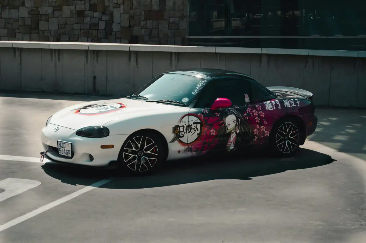 a white sports car parked in a parking lot